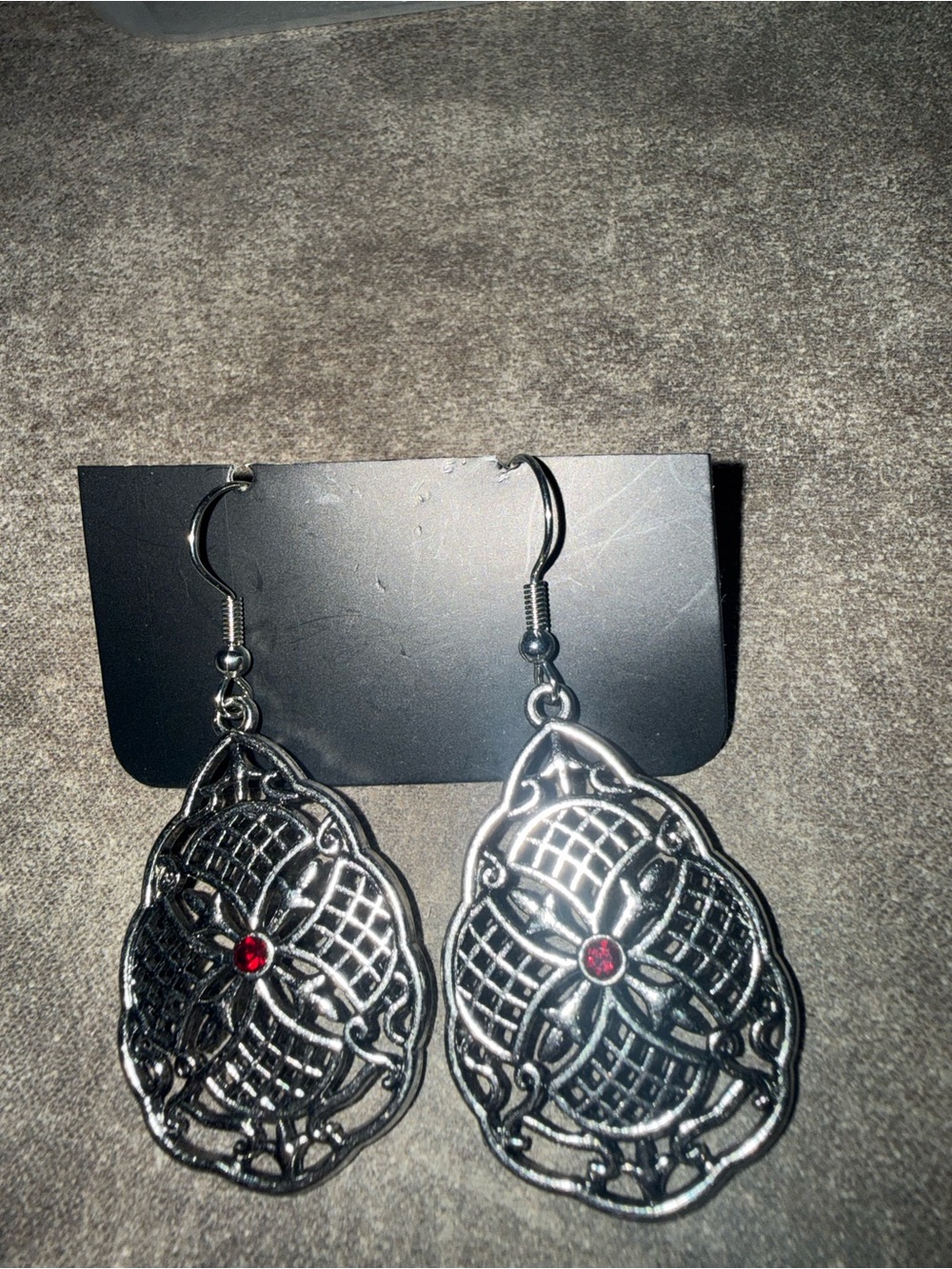 Intricate Silver-Tone Filigree Drop Earrings with Red Stone